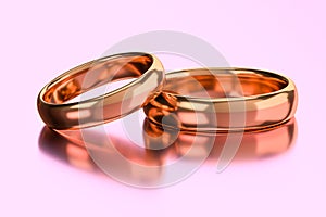 Two wedding golden rings. Unity, love, and romance concept