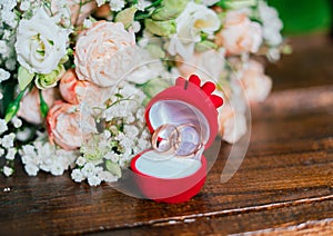 Two wedding rings on the background of a wedding bouquet