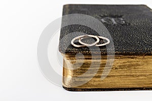 Two wedding rings on a Bible