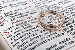Two wedding rings on a bible page