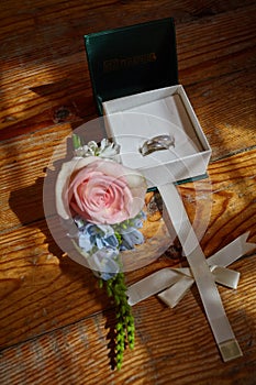 Two wedding rings in a box on a wooden background