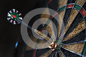 Two wedding rings hanging on the darts arrow