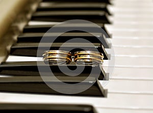 Two wedding rings on piano