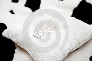Two wedding rings on a pillow close-up