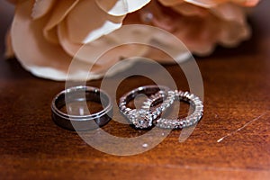 Two wedding rings, red roses