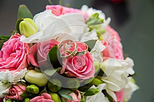 Two wedding rings, red roses