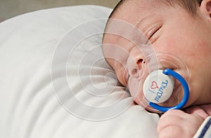 Two weeks old newborn baby boy sleeping with dummy in mouth i love you mama