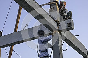 two weld worker man climb on concrete pile for welding steel make strong structure. no protect safety for work use skill and teamw