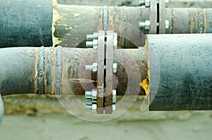 Two welded pipes with bolts and insulation close up