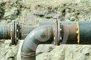 Two welded pipes with bolts and insulation close up.