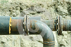 Two welded pipes with bolts and insulation closeup.