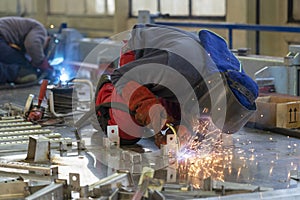 Two Welders With Torch And Welding Sparks Of Molten Metal