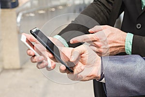 Two Westerner business man using smartphone photo