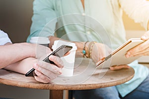 Two Westerner Business men working smartphone and tablet together