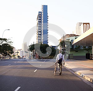 Two-wheel commuting. a businessman commuting to work with his bicycle.