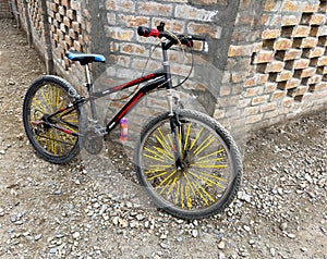 Two wheels pedal cycle parked at a bricks wall closeup photo