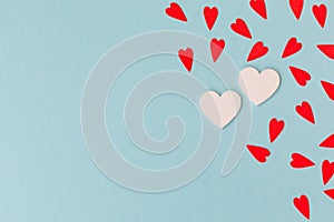 Two white big hearts and small red hearts on the blue background