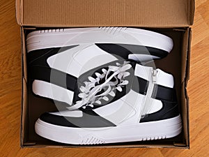 Two white and black shoes in shoebox photo