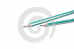 Two white and blue colored wood pencil crayon placed on an isolated white background