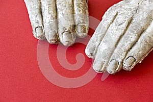 Two white broken hands of a stone statue photo