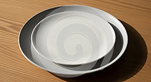 Two white ceramic plates are stacked