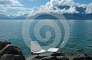 Two white chairs at Geneve lake