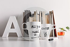 Two white coffee mug with diy decoration.