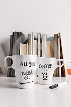 Two white coffee mug with diy decoration.