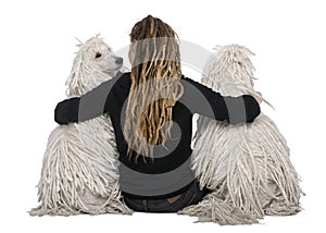 Two White Corded standard Poodles and a girl photo