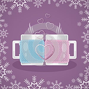 Two white cups in knitted covers, filled with a hot drink, stand opposite each other. In the foreground of the composition of the