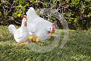 Two White decoration hens on green grass