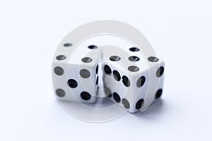 Two white dice with black dots on a white background.