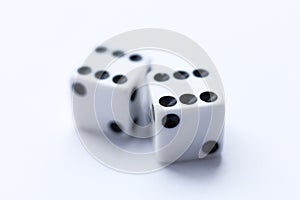Two white dice with black dots on a white background.