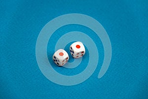two white dice isolated on a blue background
