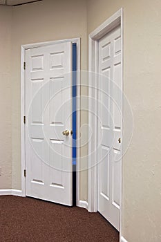 Two white doors one open