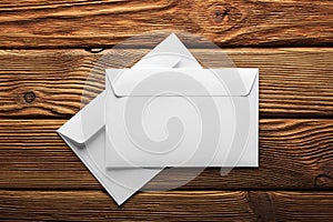 Two white envelopes with letters on old wooden dark background. Blanks for the designer. Concepts, ideas for postal services and e