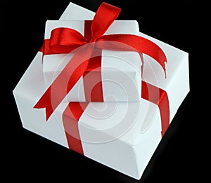 Two white gift boxes with red ribbon