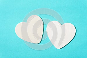 Two white hearts on green pastel background