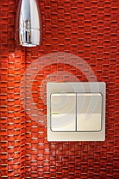 Two white lighting switchs on red wall, two choices two ways for making decision concept