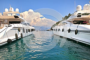 Two white luxury yachts on Mediterranean sea.