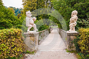 Two white marble dwarfs at the entrance to the Dwarf Garden Zwerglgarten playing Pallone game. Dwarf garden is a part of