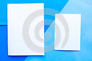 Two white mockup blanks on blue geometric background.