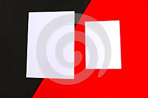 Two white mockup blanks on geometric red and black background. Copy space for the text.