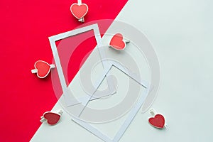 Two white mockup photo frames decorative with hearts on geometric white and red background.