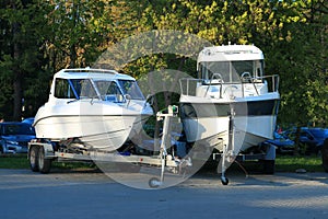 Two white motor boats on trailers