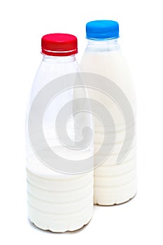 Two white plastic bottles with milk