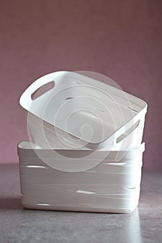 Two white plastic storage boxes