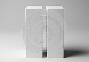 Two white rectangular blocks standing upright on a flat surface