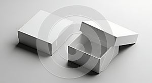 Two white rectangular boxes one closed and one open on a gray surface