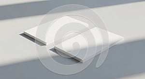Two white rectangular objects on a light gray surface with shadow